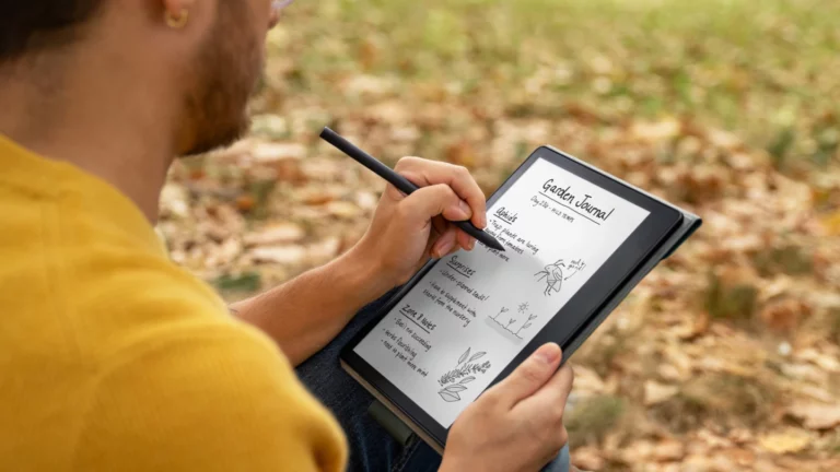 a men holding Kindle-scribe